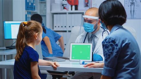 Doctor Sosteniendo La Tableta De Pantalla Verde En El Consultorio