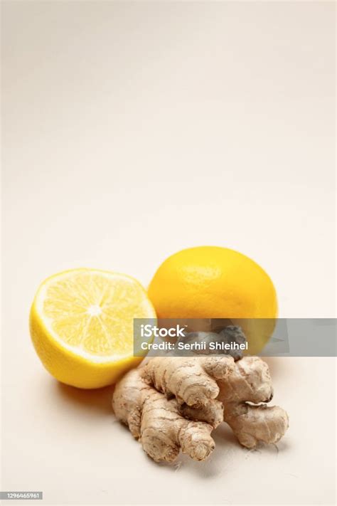 Closeup Of Ginger And Lemon On A Light Beige Background With Copy Space