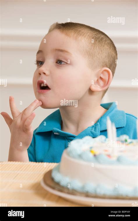 Boy Signing The Word Birthday In American Sign Language Sitting In