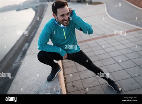 Handsome Man Stretching Before Exercising And Running Stock Photo Alamy