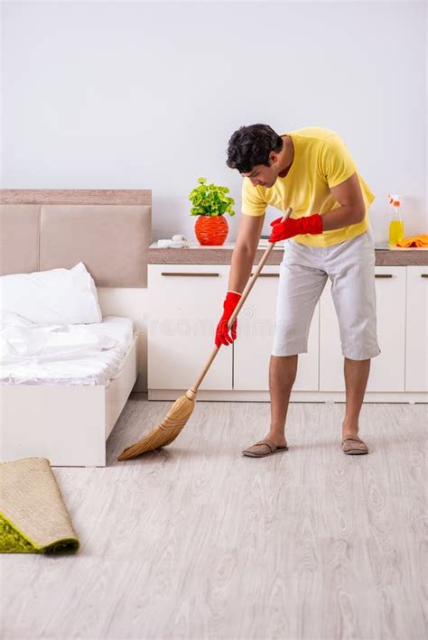 The Young Handsome Man Cleaning In The Bedroom Stock Photo Image Of