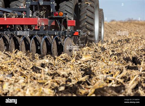 Tractor Pulling Chisel Plow Implement In Farm Field Farm Tillage