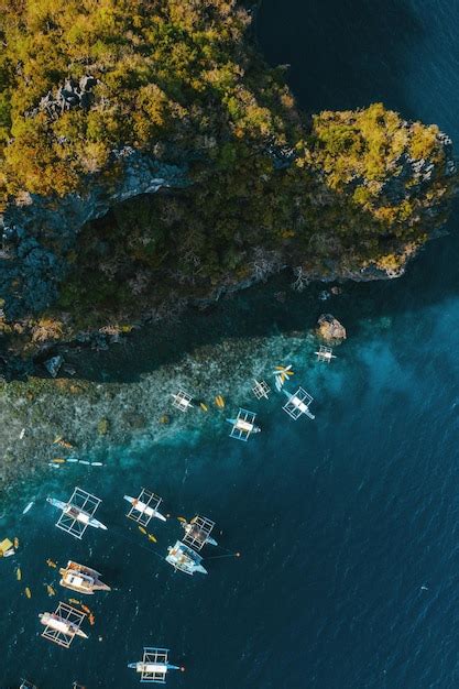 Premium Photo A Group Of Boats Floating On Top Of A Body Of Water