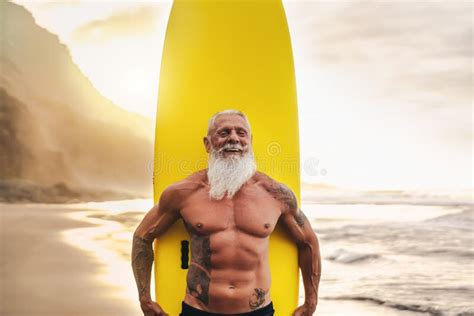 Happy Fit Senior Having Fun Surfing At Sunset Time Sporty Bearded Man