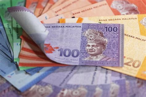 Malaysian ringgit slides to within a whisker of its 1998 record low ...