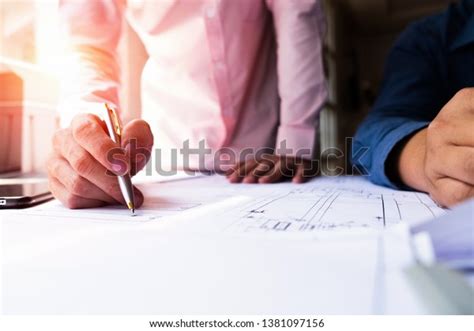 Engineers Pointing Building On Blueprint Using Stock Photo 1381097156