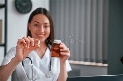 Holding Pills Young Female Doctor In White Coat Is Indoors Stock Image