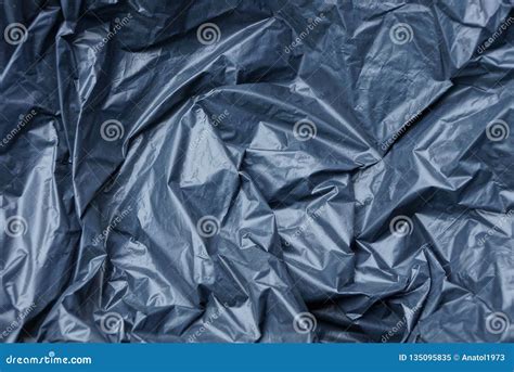 Plastic Texture Of Black Cellophane On A Crumpled Bag Stock Image