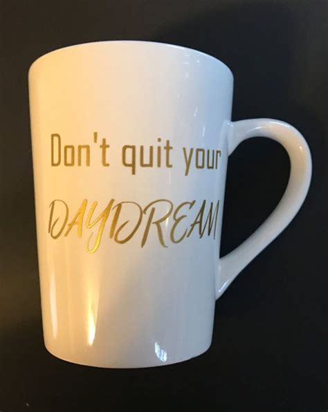 A White Coffee Mug With The Words Don T Quit Your Daydream Written On It