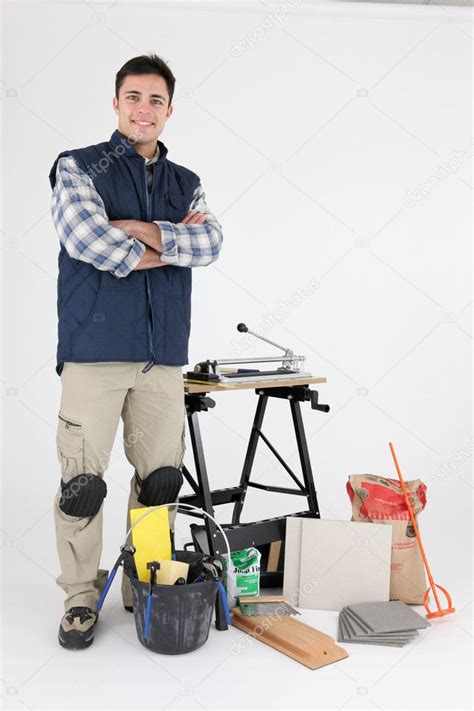 Tradesman posing with his tools and building materials — Stock Photo ...