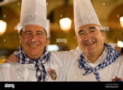 Two Basque Men Wearing White Chefs Outfits At Night During La