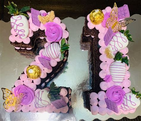 a cake that is shaped like the number twenty five with flowers and ...