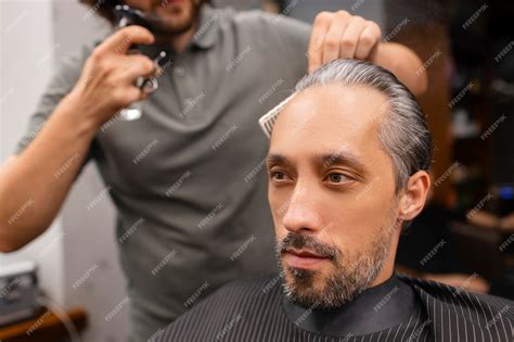 Premium Photo | Side view man getting a haircut