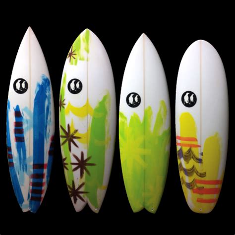 Four Surfboards Are Lined Up In A Row With Different Designs On The