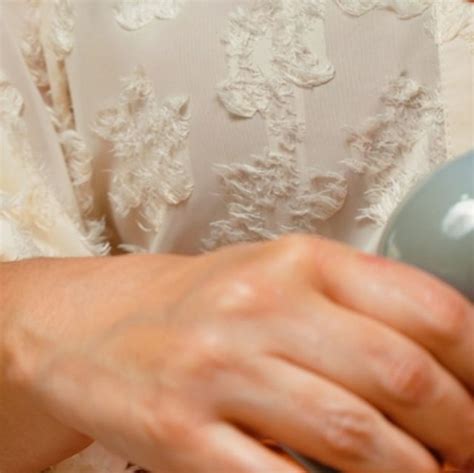 A Woman Is Holding A Hair Dryer In Her Hand