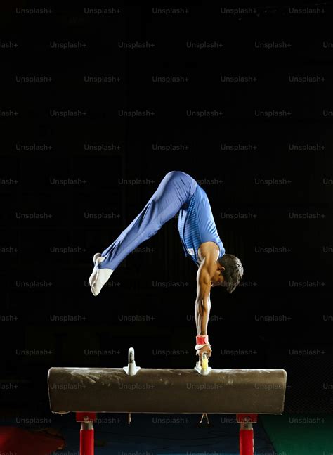 A woman doing a handstand on a balance beam photo – Olympic sport Image