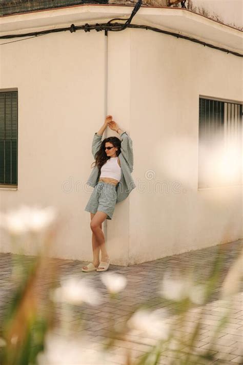 In Full Length Young Caucasian Woman Stands At Street Looks Away