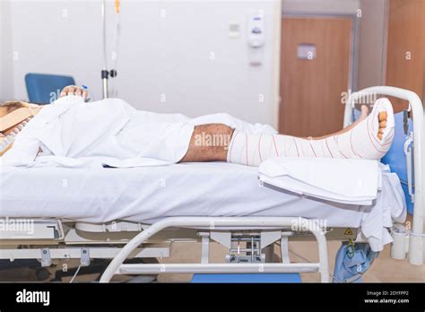 Patient Man In Hospital Bed With Broken Leg Draw Level