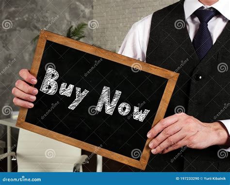 Business Concept Meaning Buy Now With Sign On The Sheet Stock Photo