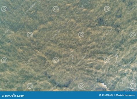 The Surface Of The Sea In Shallow Water With Waves And Muddy Water