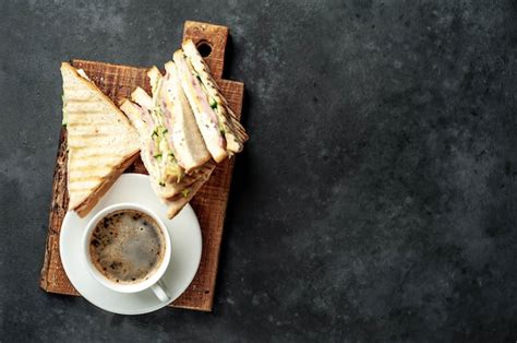 Coffee and sandwiches with ham, cheese, tomatoes, lettuce and toasted ...