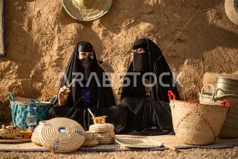 Two Saudi Arabian Gulf women inside an old popular market, wearing the ...