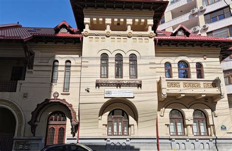 An Old Building With Many Windows And Balconies On The Top Floor Along