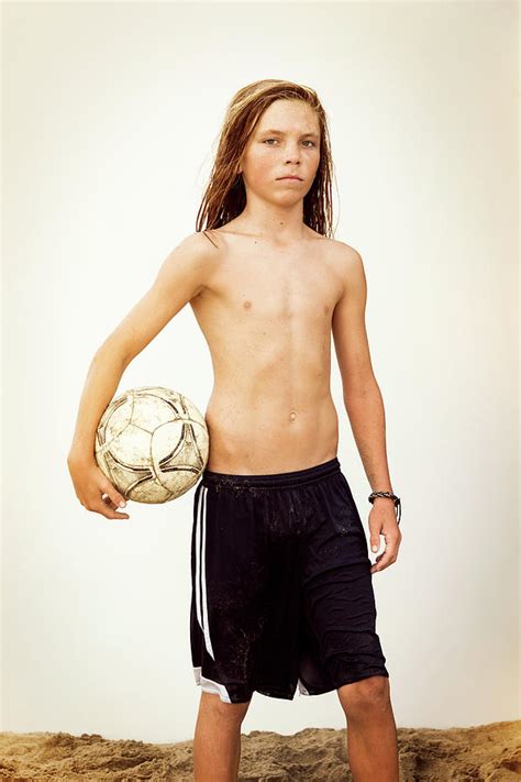 Portrait Of Shirtless Boy Holding Soccer Ball Standing Against Clear