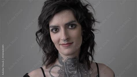 Portrait Of Confident Transgender Woman With Neck Tattoo And Piercings