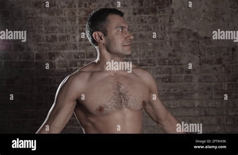 Muscular And Fit Mature Bodybuilder Posing Demonstrates The Core Muscles Stock Video Footage Alamy