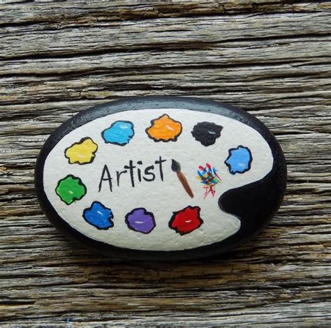 A Painted Rock With The Words Artist On It