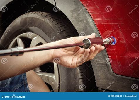 Man Working on a Car Dent Self Repair with Reverse Hammer Set of Tools ...