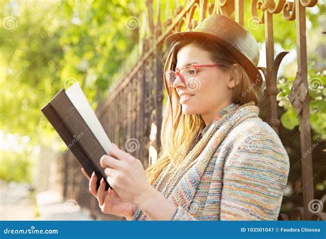 Young Woman Reading A Book Outdoors Stock Image Image Of Outside