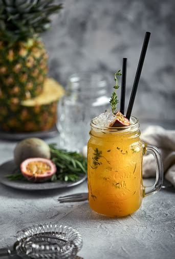 Tropical Cocktail With Passion Fruit Lime And Mint On A Gray Background