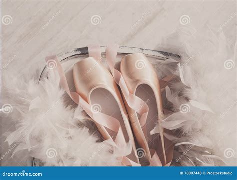 Pink Ballet Pointe Shoes And Feather On White Wood Background Stock