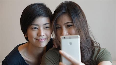 Premium Photo Portrait Of Smiling Young Woman Using Mobile Phone