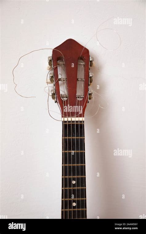 Close-up of broken guitar by white wall Stock Photo - Alamy