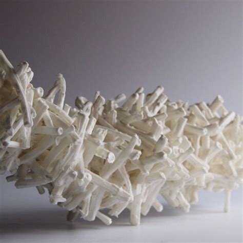 A Sculpture Made Out Of White Sticks On A Table