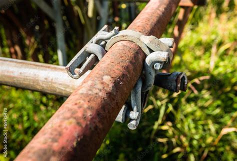 Tubes and clamp of a scaffold from close Stock Photo | Adobe Stock