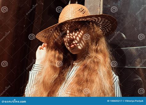 Portrait Of Young Red Haired Model In Straw Hat With Shadow On H Stock