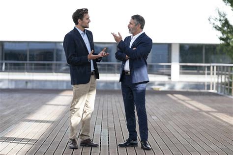 Business People Having Discussion While Standing On Office Building