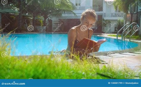 Blonde Girl In Bikini Reads Book In Pool Leaning On Barrier Stock Video Video Of Person Lawn