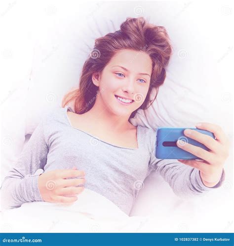 Selfie in white bed stock photo. Image of emotion, lying - 102837382