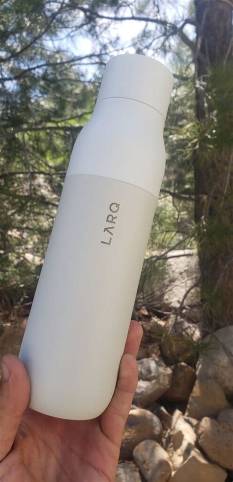 Larq Self Cleaning Water Bottle In Hand Closeup The Backpack Guide