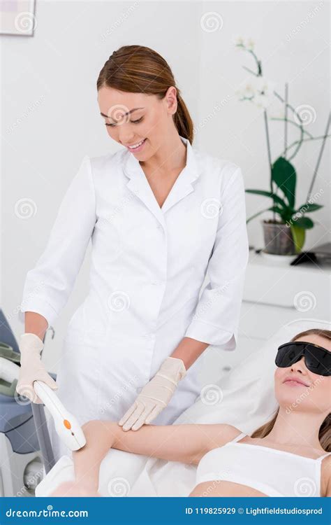 Woman Receiving Laser Hair Removal Procedure On Arm Made By