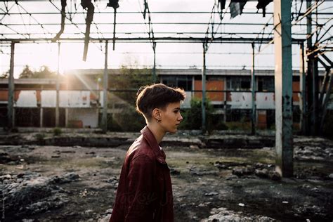 Attractive Woman Standing In The Abandoned Factory By Stocksy Contributor Boris Jovanovic