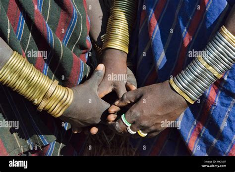 Mursi tribe people in traditional clothing wearing bracelets, Mursi ...