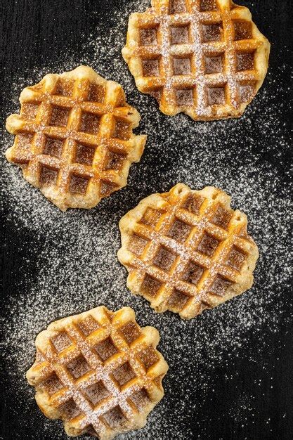 Premium Photo Belgian Waffles Sprinkled With Sugar On Black Table Top