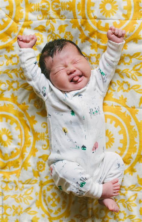 "Newborn Baby Stretching" by Stocksy Contributor "Lauren Lee" - Stocksy