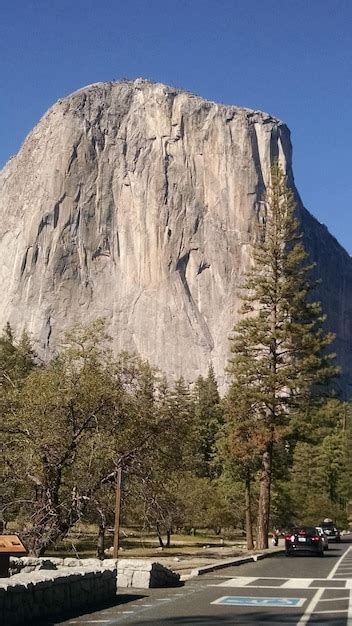 Premium Photo Road By Trees Against Rocky Mountain At Yosemite Valley